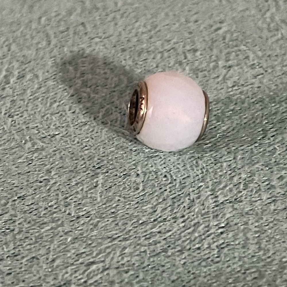 Abstract silver charm with faceted opalescent white crystal